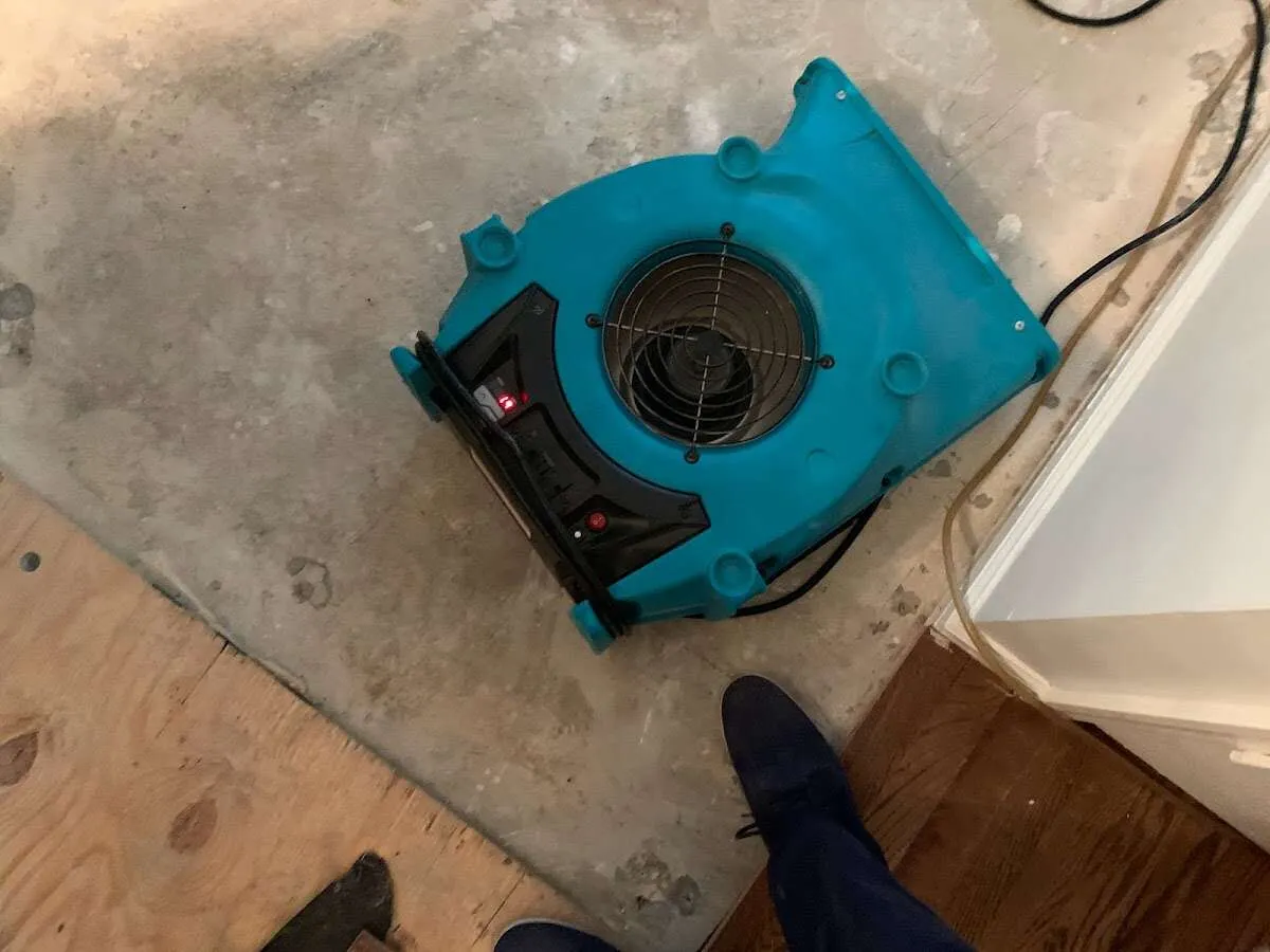 Air mover drying subfloor during Commercial Water Damage Restoration in Lake Norman of Iredell